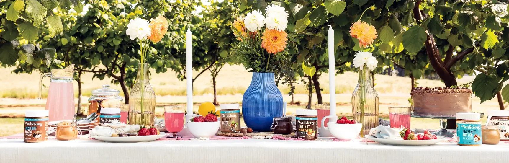 image of all of our products on a table with flowers and fruit