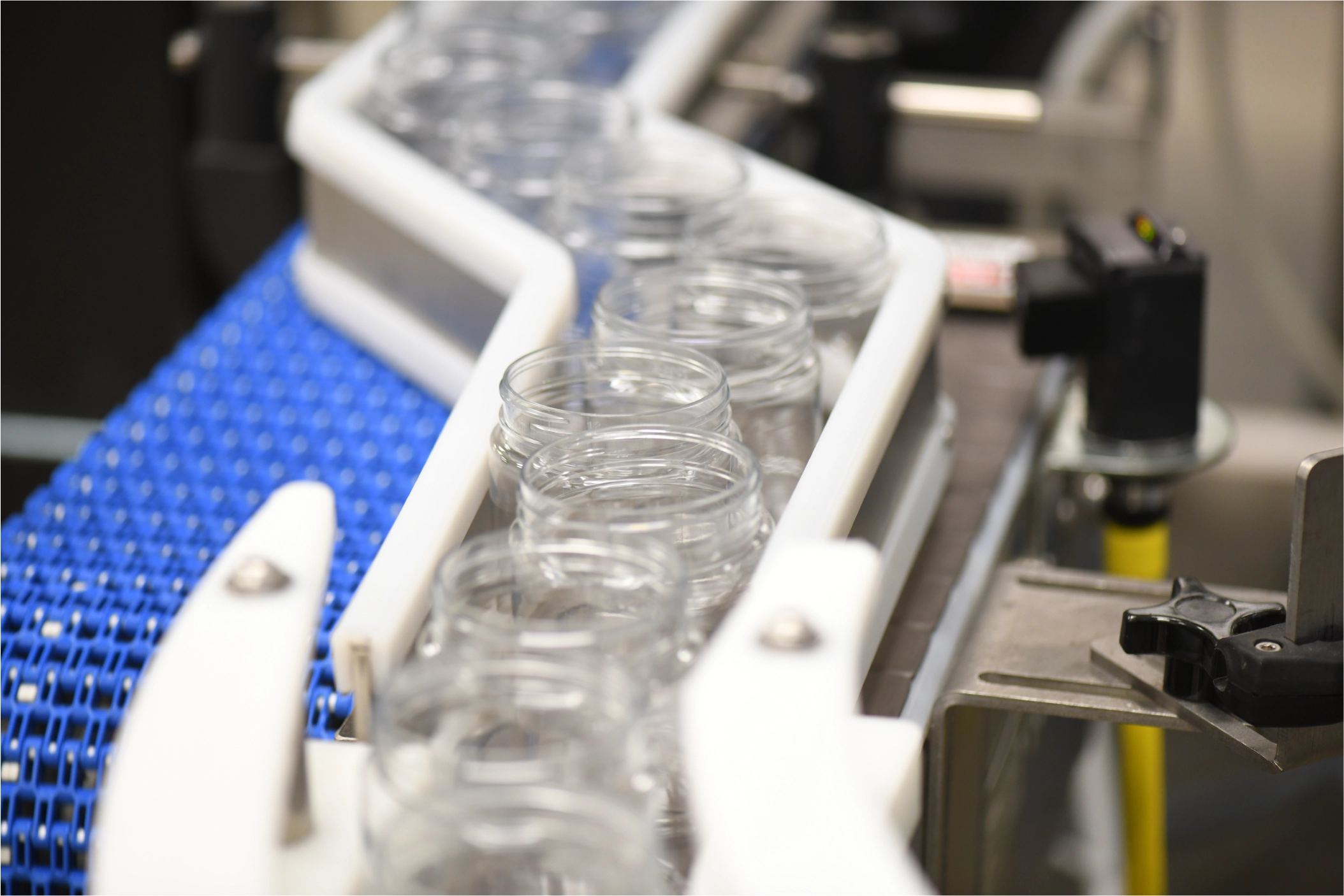 Jars waiting to filled on conveyor 